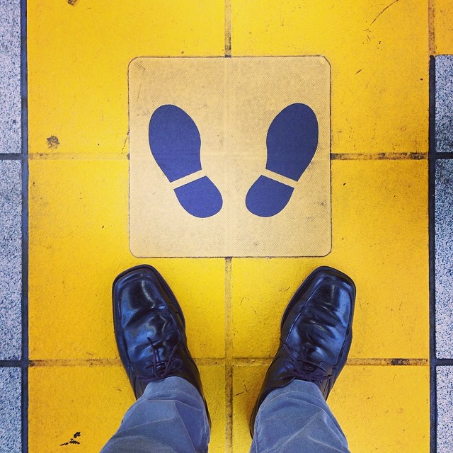 Standing in a line, behind a transparent man.